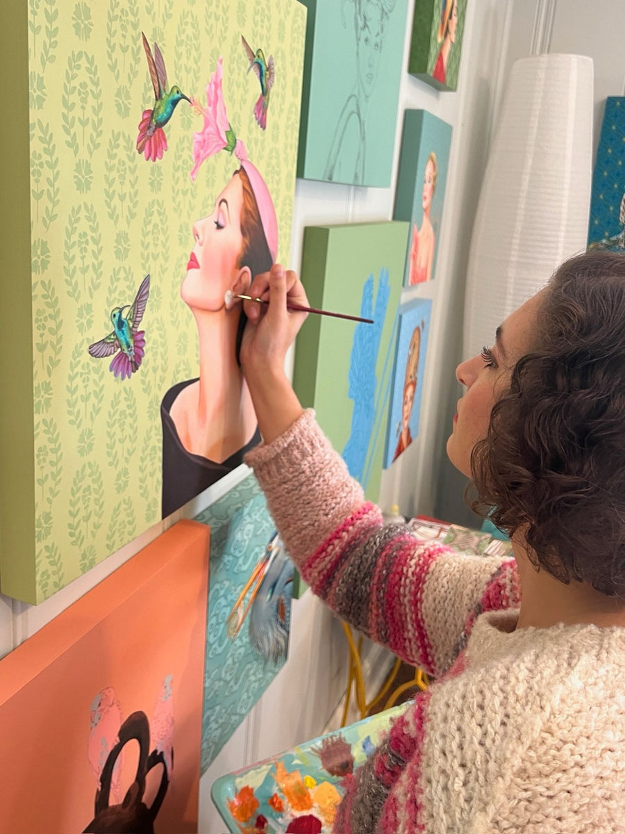 Ashton painting a hummingbird portrait in her studio